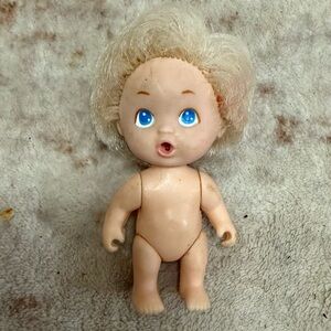 This is a vintage Tyco Playful Quints Blonde Baby Boy Doll from 1990.